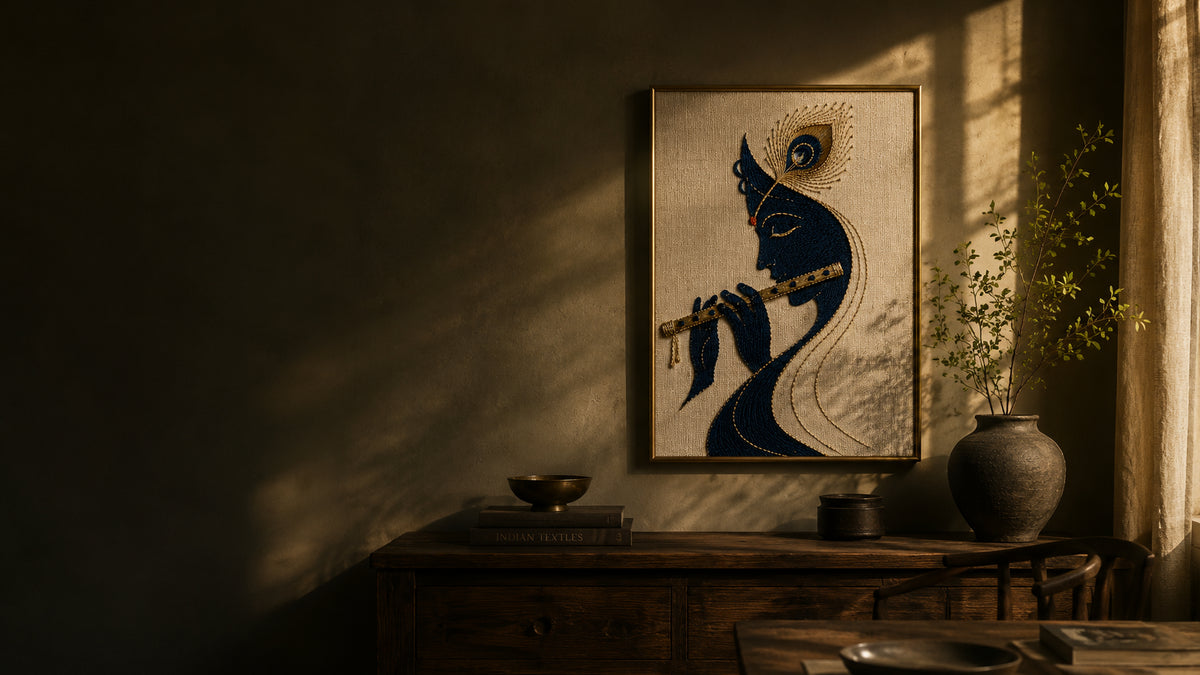 Framed Venu Gita artwork on a wall in warm evening light